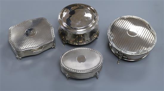 Four early 20th century silver trinket boxes, Dia 10.5cm (largest)